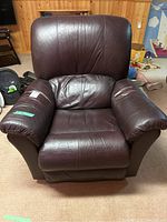 Front view of the leather recliner showing overall condition, seat, arms and backrest.