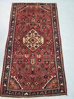 Full view of Hamedan Persian rug showing central medallion and border design in rich abrash colors typical of vegetable dye wool.