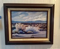Full view of framed painting showing desert landscape and signature.