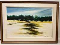 Full view of the framed oil painting depicting a rural landscape with fields, houses, forest, and church steeple under a cloudy sky.