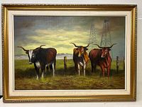 Frontal view of the oil painting showing three bulls in a field with oil rigs and cloudy sky, framed.