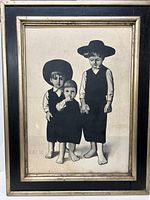 Full view of framed artwork showing three barefoot children in dark clothing and hats, signature visible bottom left.