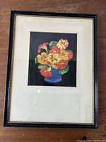 Framed stencil on silk floral artwork by Thomas Todd Blaylock showing vivid nasturtium flowers in a blue vase against a black background.