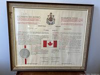 Front view of framed proclamation showing text, maple flag graphic, embossed seal and crests