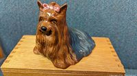 Front and top view of the Beswick Yorkshire Terrier dog figurine showing detailed fur and pink bow.