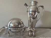 Full front view of the set including cocktail shaker, covered serving dish, and salt & pepper shakers