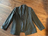 Vintage Kasper & Company blazer laid flat on floor showing overall condition and style