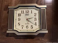 Front view of vintage Seiko quartz wall clock with beige and brown frame and clear Arabic numerals.