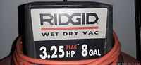 Close-up of RIDGID Wet Dry Vac label showing 3.25 peak horsepower and 8 gallon capacity.