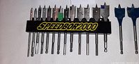 Full set of Speedbore 2000 wood drill bits ranging in size from 1/4" to 1 1/2" in holder.