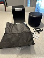 Echo Subwoofer with original box, carrying bag, and power cable on a white countertop.