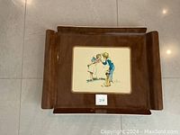 Top-down view of large vintage acrylic serving tray with brown background and central Norman Rockwell image of boy whispering to girl with dog beside them.