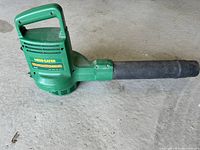Full side view of green Weed Eater GroundSweeper 2510 leaf blower showing handle and blower tube.