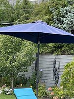 Navy blue rectangular canopy outdoor umbrella in garden setting