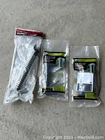Two EZ Grip Gate Handles and one Everbilt Gate Spring, all new in original packaging.