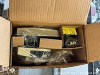 Open box showing Schlage deadbolt components individually wrapped inside