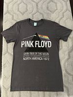 Front view of the black Pink Floyd T-shirt with Dark Side of the Moon prism and text design