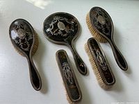 Five-piece vanity set arranged on white surface