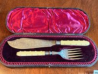 Fish serving knife and fork in original fitted velvet and satin-lined case