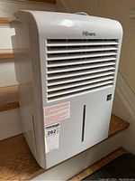 Front view of white Premiere dehumidifier with vents and water level indicator.