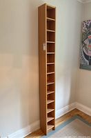 Full view of the tall pine shelf from an angle, showing its height and narrow profile.