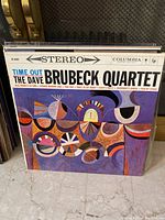 Front cover of 'Time Out' by The Dave Brubeck Quartet album with abstract colorful art and Columbia label.