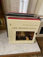 Front view of The Spanish Style album with artwork depicting a classical musical scene in muted colors.