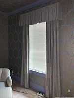 Curtain set with valence and panels hung over window. Panels approximately 96x36 inches, made of synthetic fabric with patterned texture in mauve and beige tones.