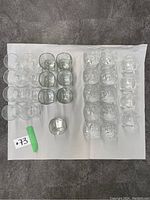 Top-down view of all glassware displaying the 4 types: rounded highball, square highball, square cocktail/rocks, rounded cocktail/rocks.