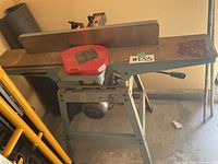 Full view of the jointer showing tabletop, fence and stand