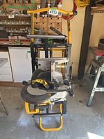 Front view of DeWalt miter saw mounted on wheeled stand