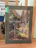 Full view of the framed print showing the abstract forest scene with tall trees and signature by Emily Carr