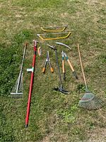 Full lot laid out on grass showing all garden and trimming tools.