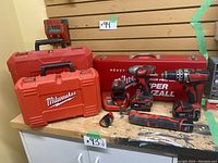 Overview of two TSTAK cases, metal Super Sawzall case, cordless tools and accessories on workbench.