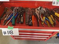 A variety of pliers, cutters, wrenches and screwdrivers laid out in a red tool drawer