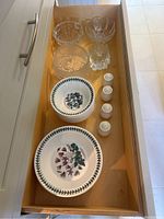 Drawer with Royal Doulton salt and pepper shakers, Portmeirion floral plates and bowls, and clear crystal bowls