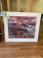 Full view of the framed artwork showing the red maple by the river, including the wooden frame and white mat.