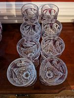 Top down view showing the intricate floral and star cut pattern inside the goblets and the red etched bird and leaf design around the openings.