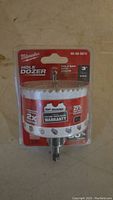 Front view of Milwaukee 3 inch Hole Dozer hole saw with arbor in sealed packaging showing product details and branding.