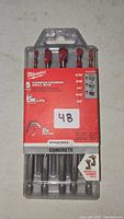 Front view of sealed Milwaukee 5 piece carbide hammer drill bits package showing bit sizes and branding.