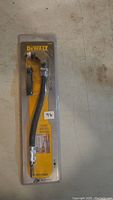 Full packaged view of Dewalt 12 inch right angle flexible shaft holder showing product, branding, and additional handle inside clear plastic package.