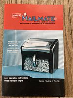 Instruction manual cover displaying the Staples Mailmate model with shredding image and product support contact info.