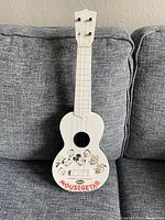 Front view of white 20-inch ukulele with Disney characters and Mousegetar text on body