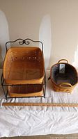 Full view of two-tier Longaberger basket set with metal stand, smaller basket with fabric liner, and ruler for size reference.