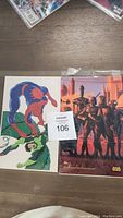 Two collectible cards; Spiderman and Star Wars, both in clear plastic covers