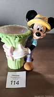 Full view of the Mickey Mouse ceramic vase planter showing the character and green vase with leaf-like texture.