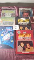 Photo showing five Star Trek books including 25th Anniversary Special magazine and various compendiums with different colored covers