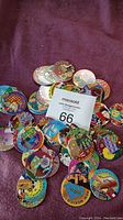 Overview of multiple state capitol pogs scattered on cloth.