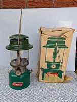 Side view of the Coleman 335 lantern next to its original box showing condition and branding.