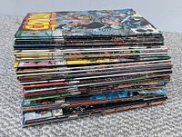 Stack of 51 Conan The Barbarian comic books laying flat, showing spines and some cover edges.